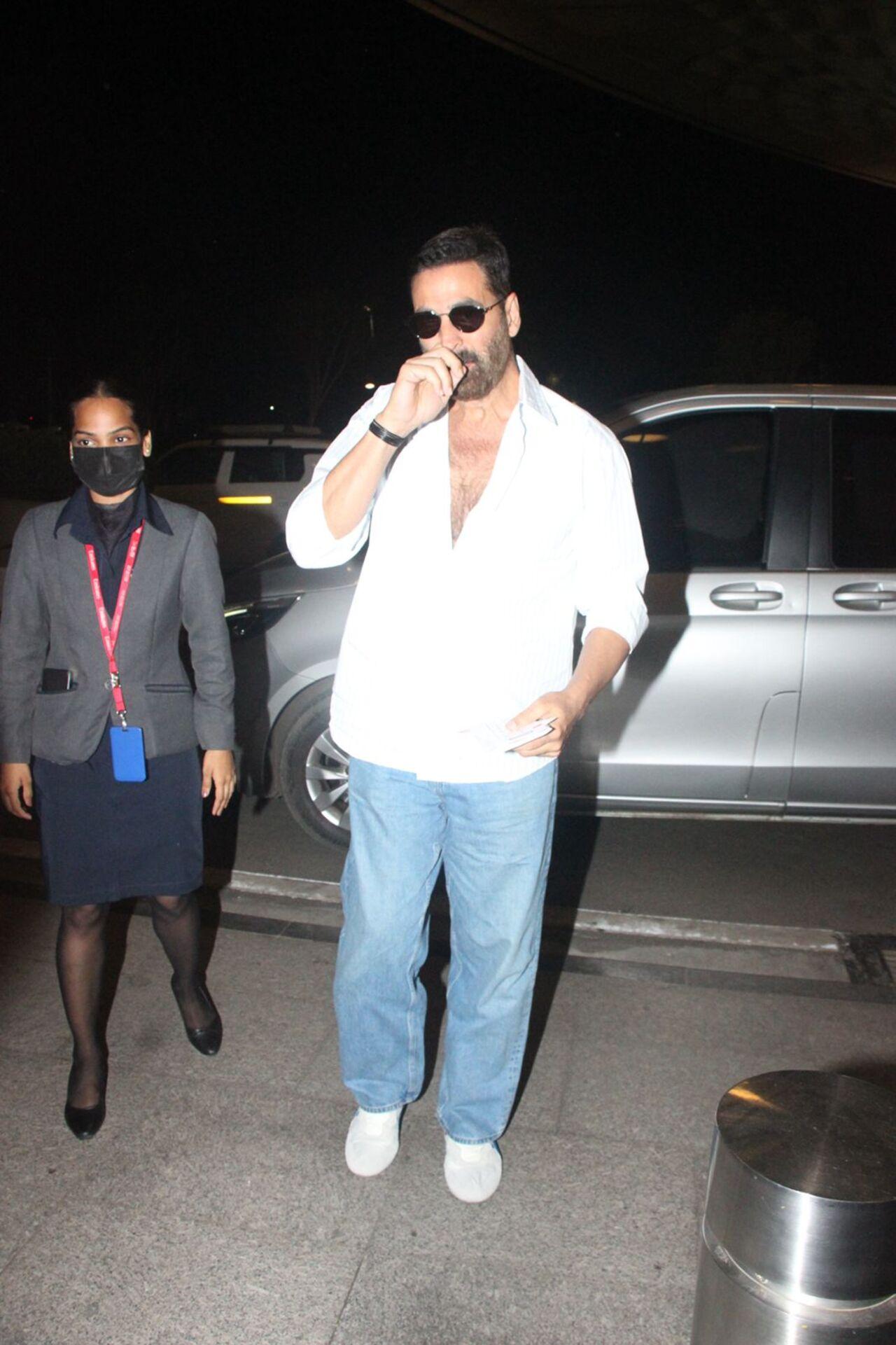 Akshay Kumar kept it effortlessly cool in his airport look, a crisp white shirt with a deep neckline, light blue jeans, and white sneakers.